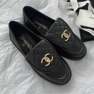 CHANEL Quilted Black Loafers with Gold Accent